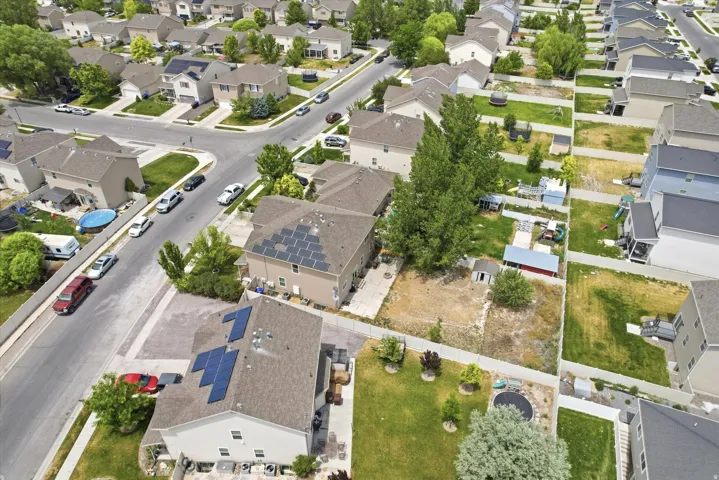 Residential neighborhood featuring multiple two-story homes with shingle roofs and solar panels