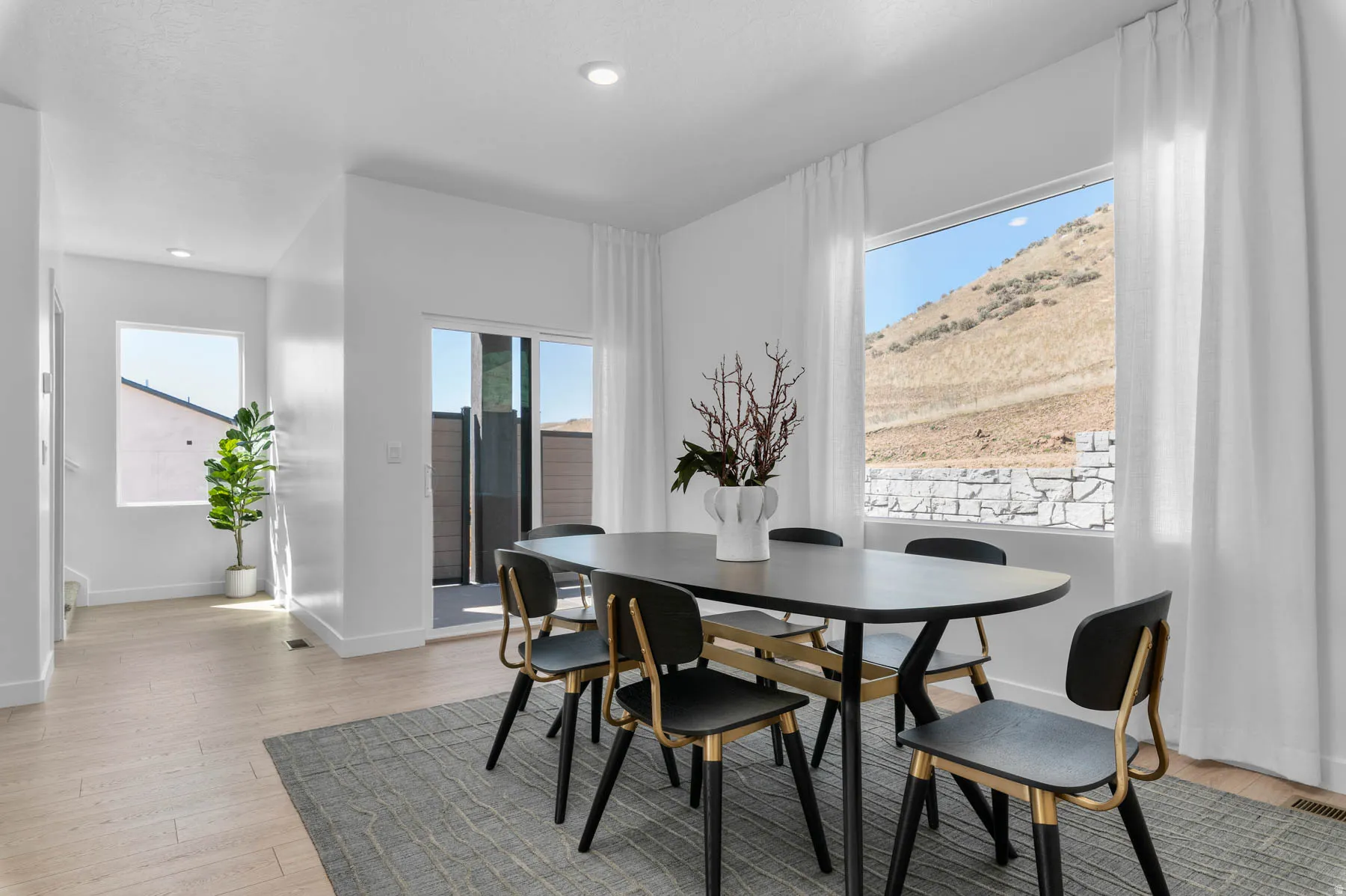 Dining area featuring light wood-finish flooring, white walls, and recessed lighting