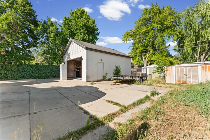 Detached garage structure with a gabled roof and white siding