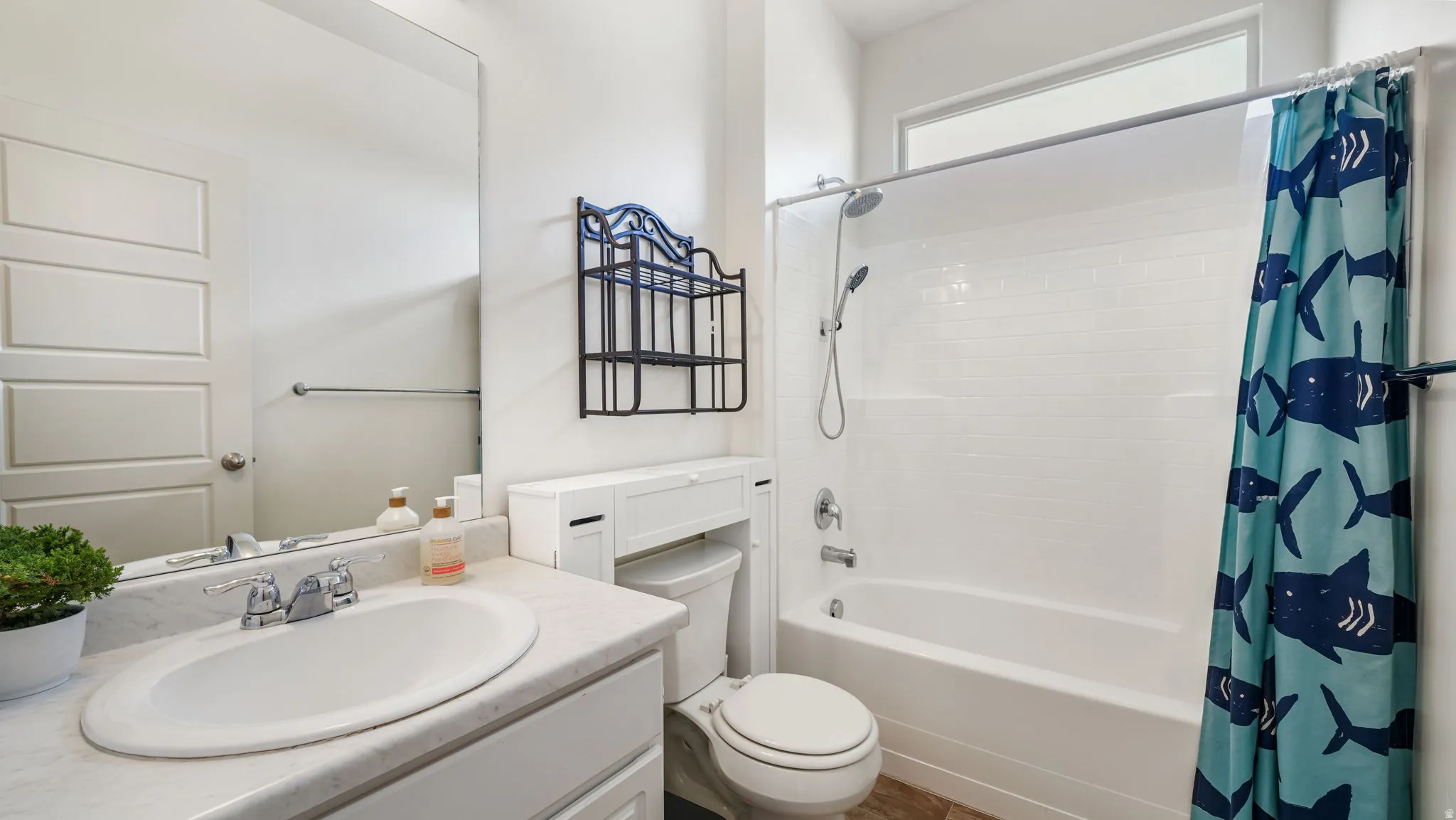 Bathroom featuring a white vanity with an undermount sink and a light-colored countertop