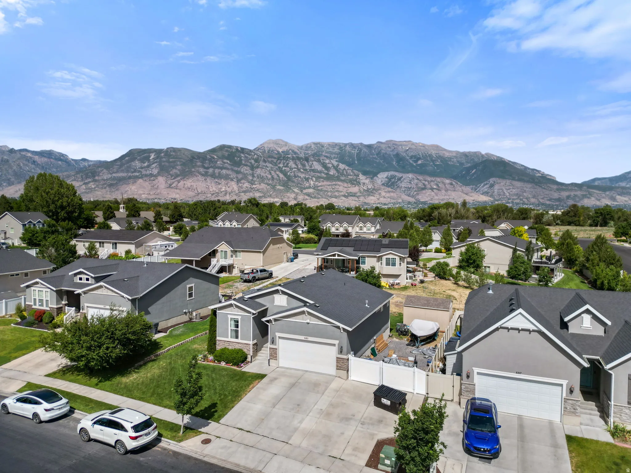 Suburban neighborhood setting with visible mountain backdrop