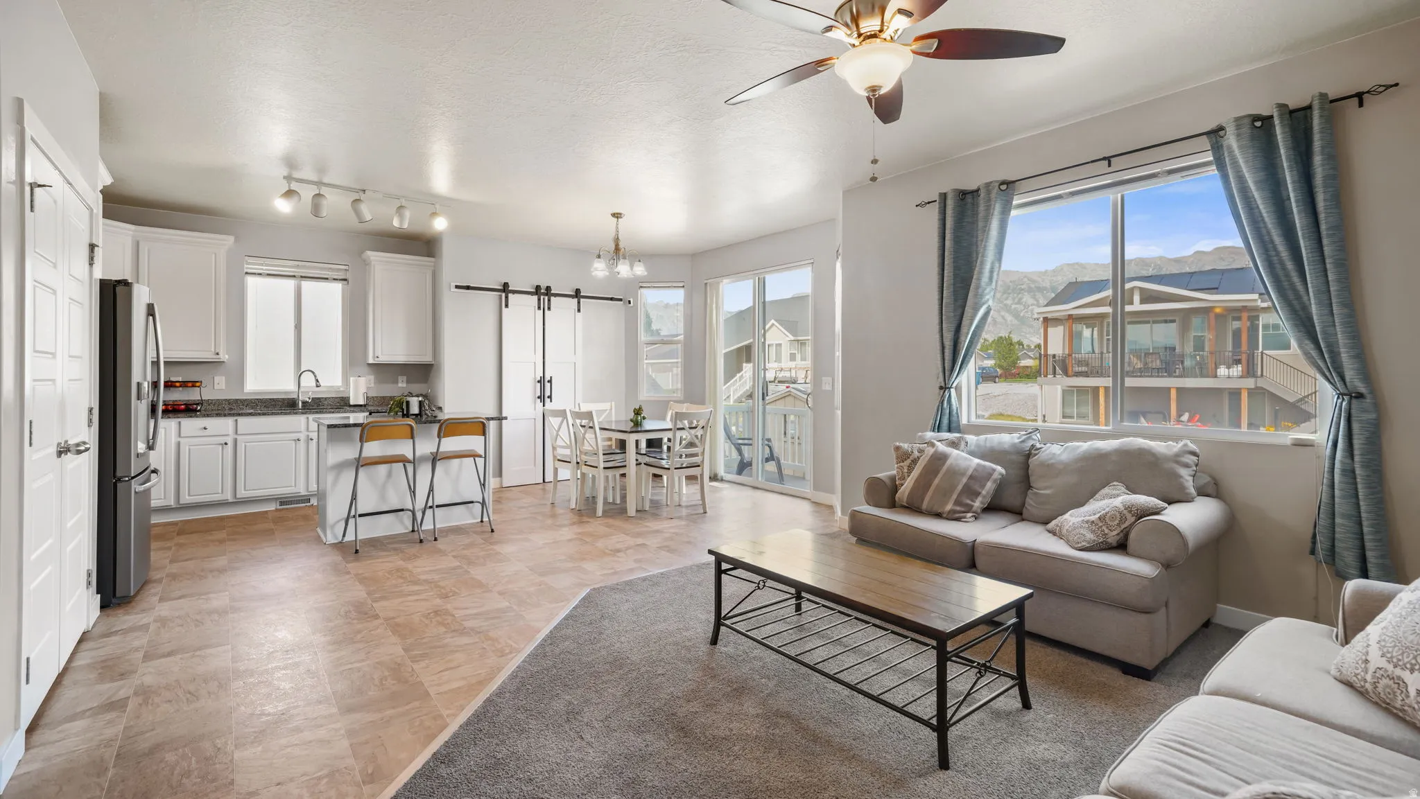 Open-concept living space featuring a kitchen, dining area, and living room