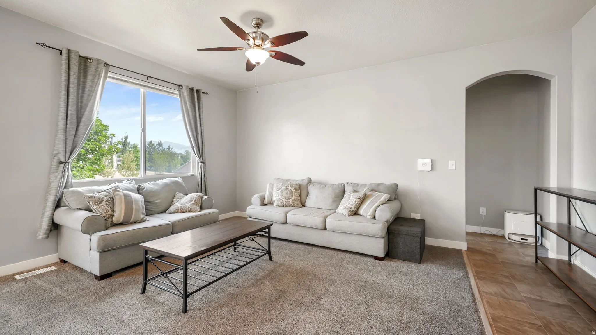 Spacious interior with neutral wall tones and a large window