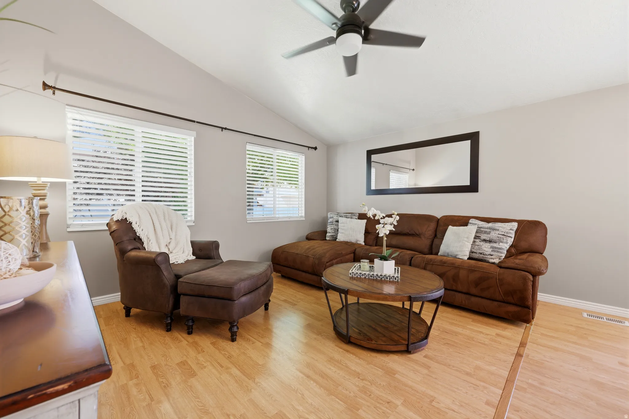 Living area featuring vaulted ceilings and wood-finish flooring