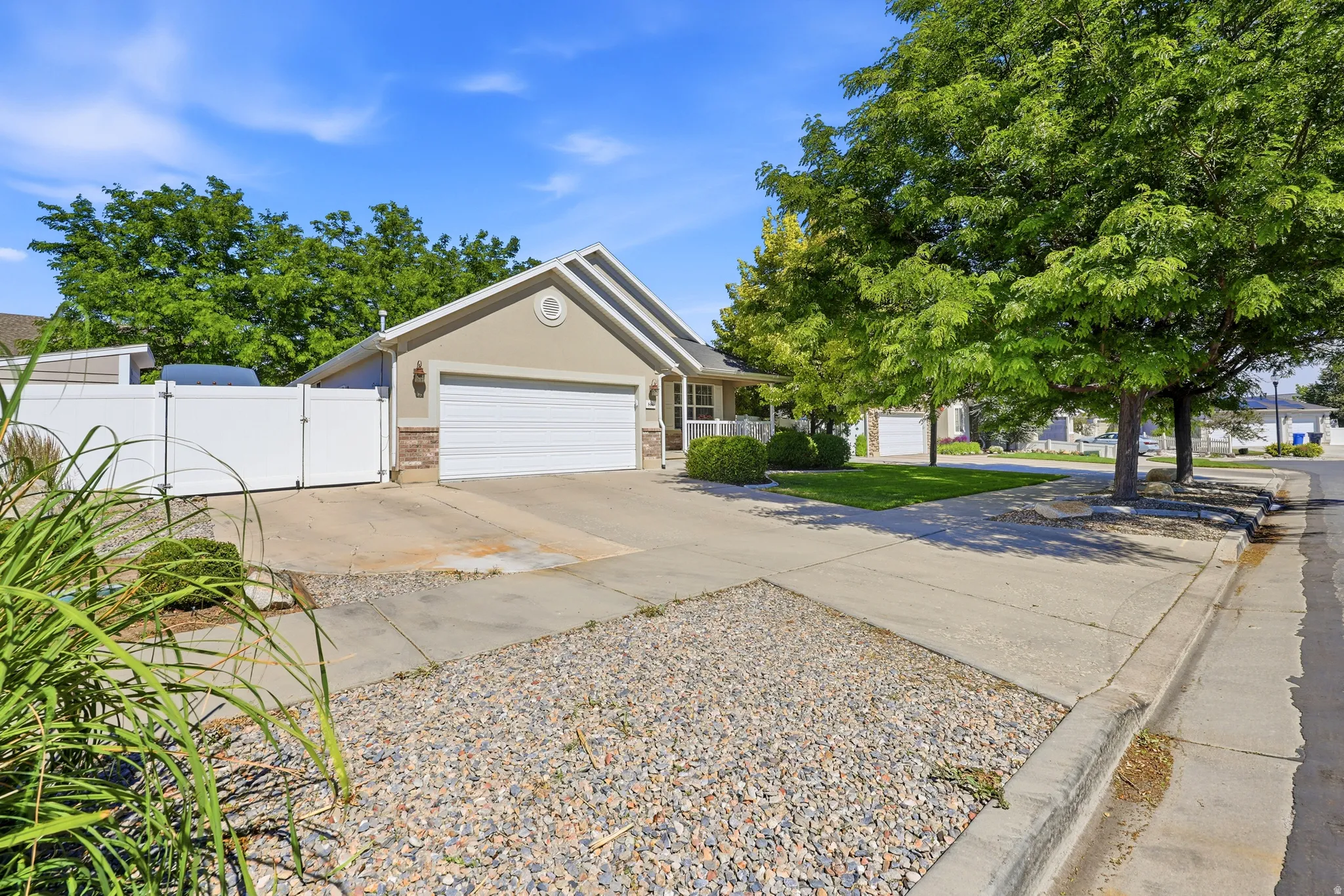 Stucco exterior residence with an attached garage, featuring a white garage door