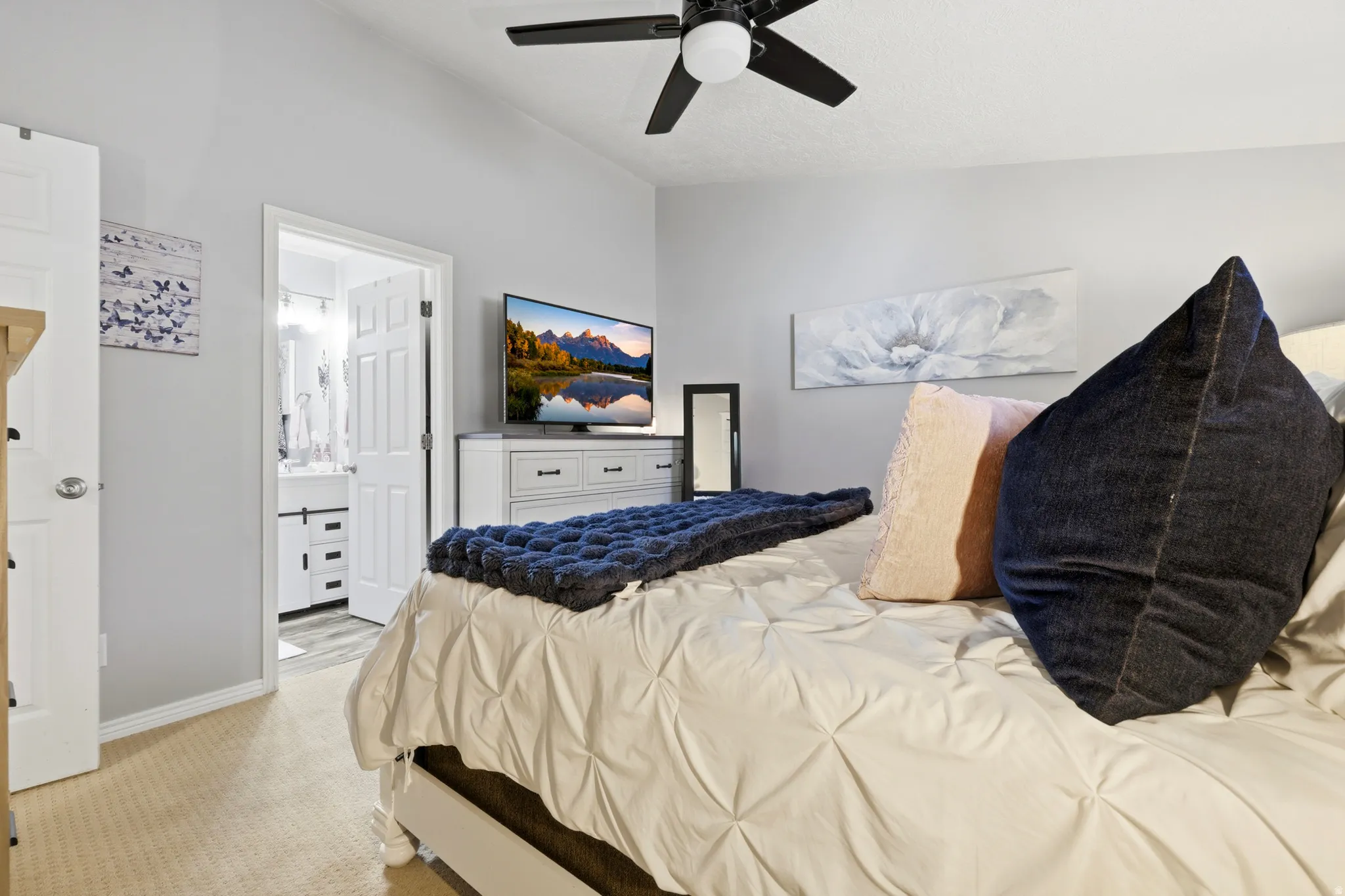 Bedroom featuring vaulted ceilings, a ceiling fan, and carpet flooring