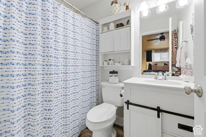 White vanity with a barn door style cabinet and an integrated sink