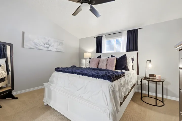Light gray walls with vaulted ceiling and a ceiling fan