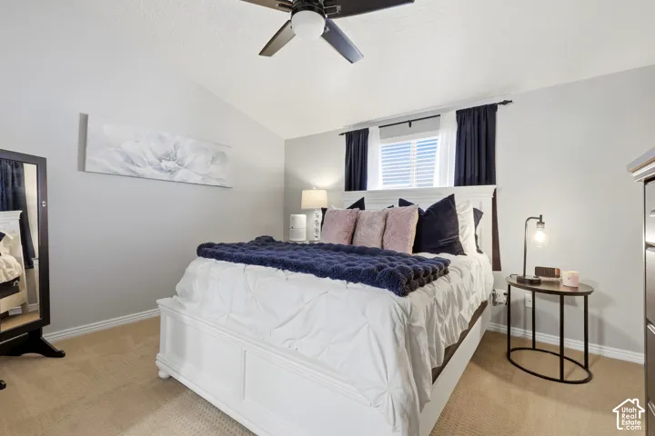 Light gray walls with vaulted ceiling and a ceiling fan