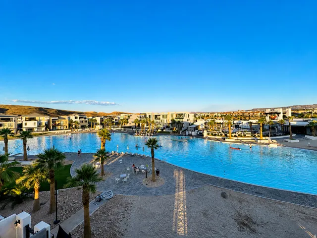 Expansive lagoon-style pool with surrounding properties featuring modern architecture
