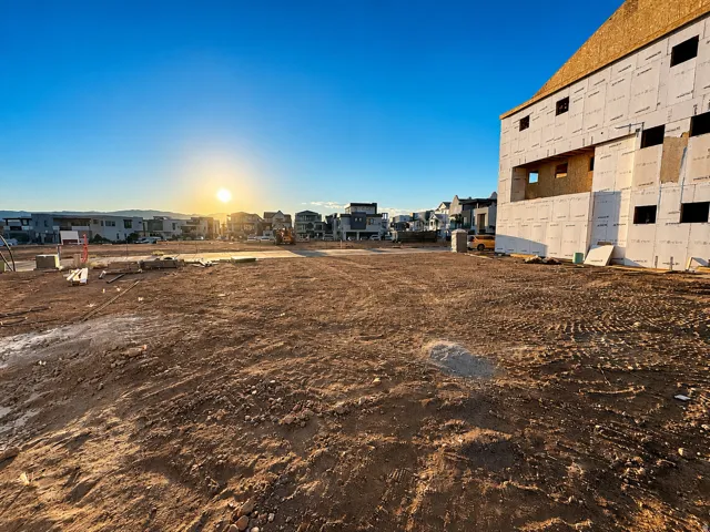 Expansive undeveloped lot with partial framing visible on a structure