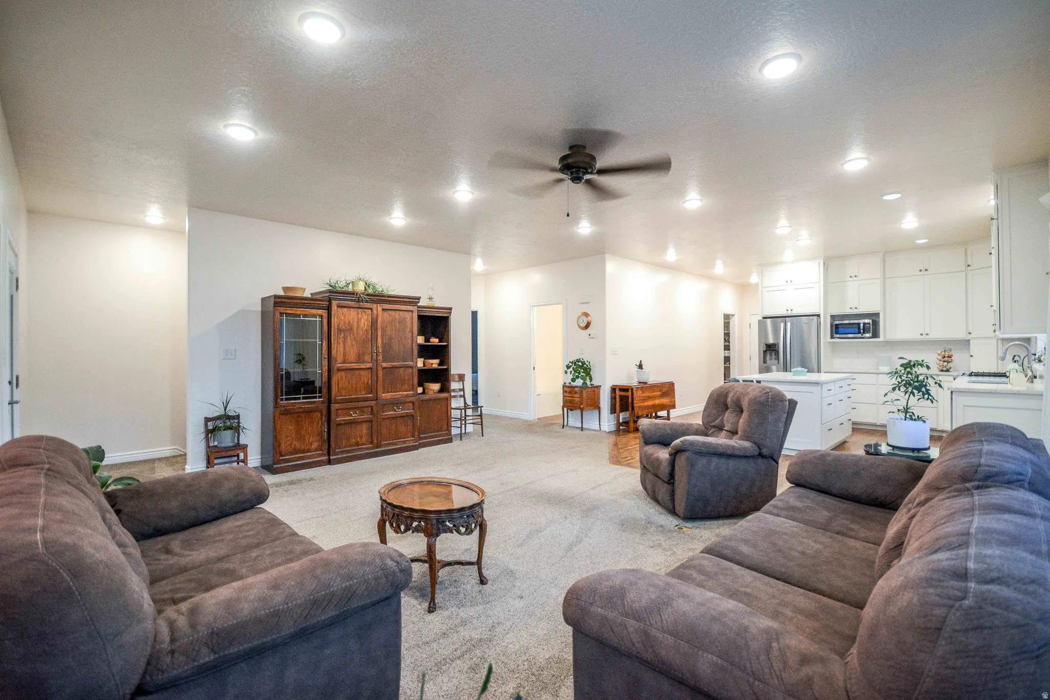 Open-concept living space featuring recessed lighting and a ceiling fan