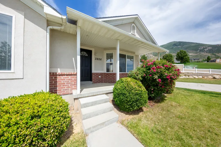Stucco and brick facade with an inviting covered porch