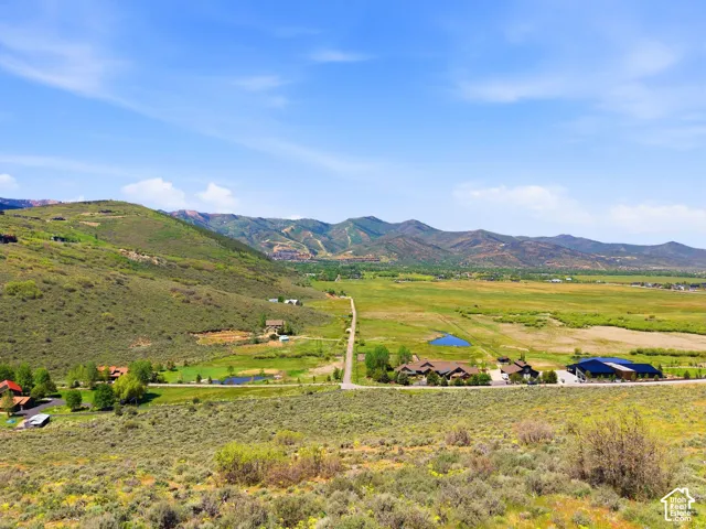 Expansive mountain landscape featuring varied terrain and multiple custom-built properties