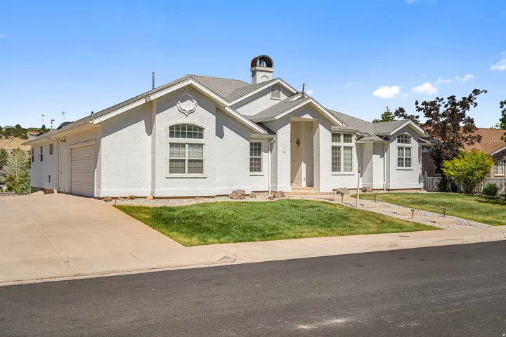 White stucco exterior with a multi-gabled roofline