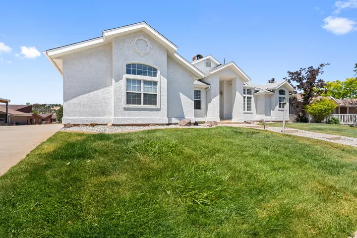 Contemporary stucco exterior featuring a gabled roofline and multiple window styles