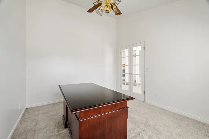 Bright room with neutral wall paint and plush carpeting