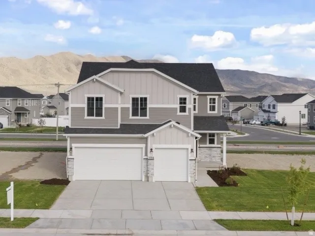 Contemporary two-story residence featuring a two-car garage and an additional single-car garage