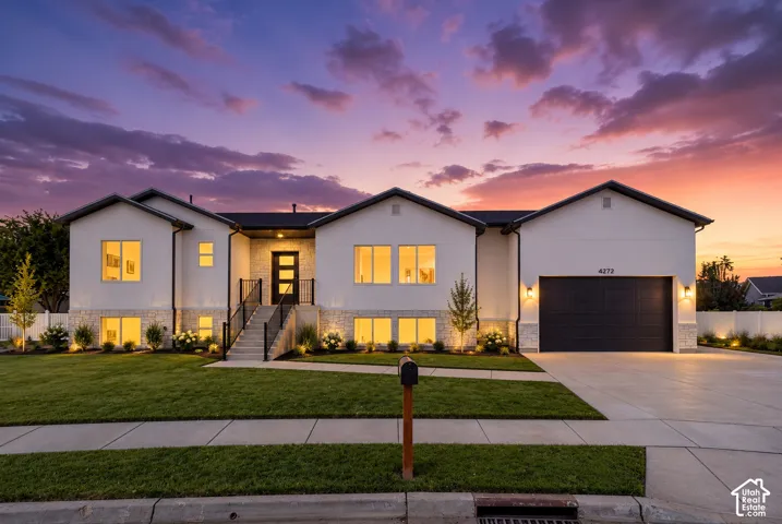 Contemporary exterior with white stucco and stone veneer accents