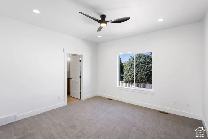 Recessed lighting, ceiling fan, white trim, white walls, and gray carpet