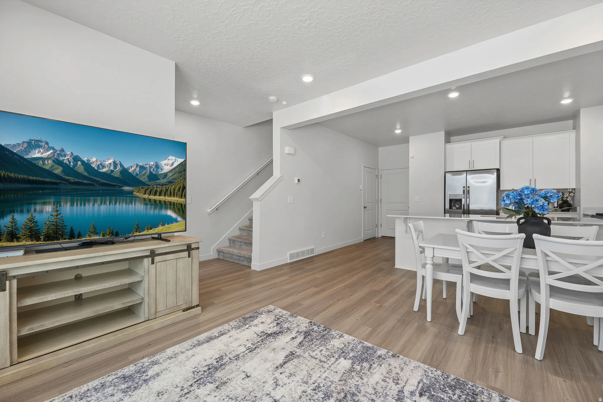 Open-concept living area featuring light wood-finish flooring