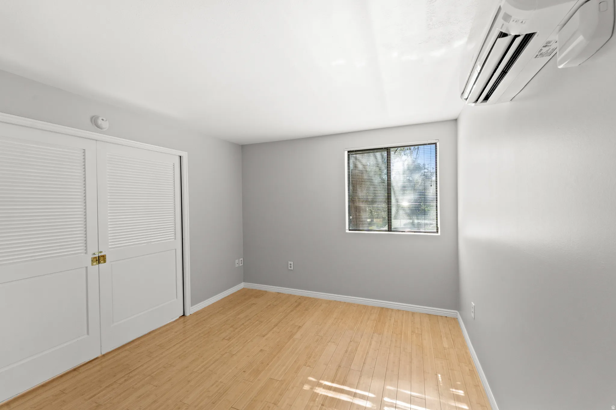 The second bedroom has large French doors (shone closed) make it easily usable as a bedroom, office, or additional living space.