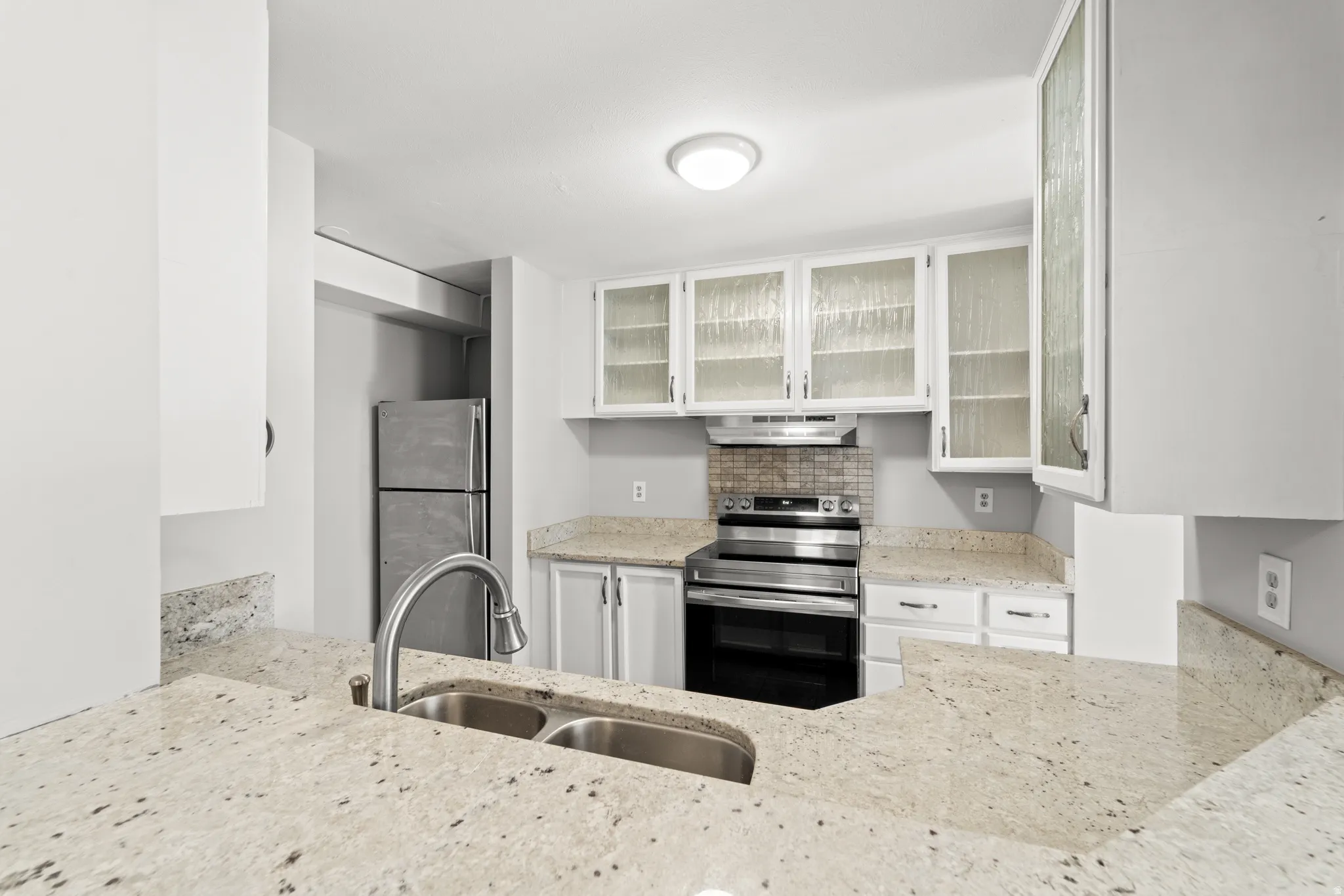 Updated kitchen featuring granite countertops and abundant workspace.