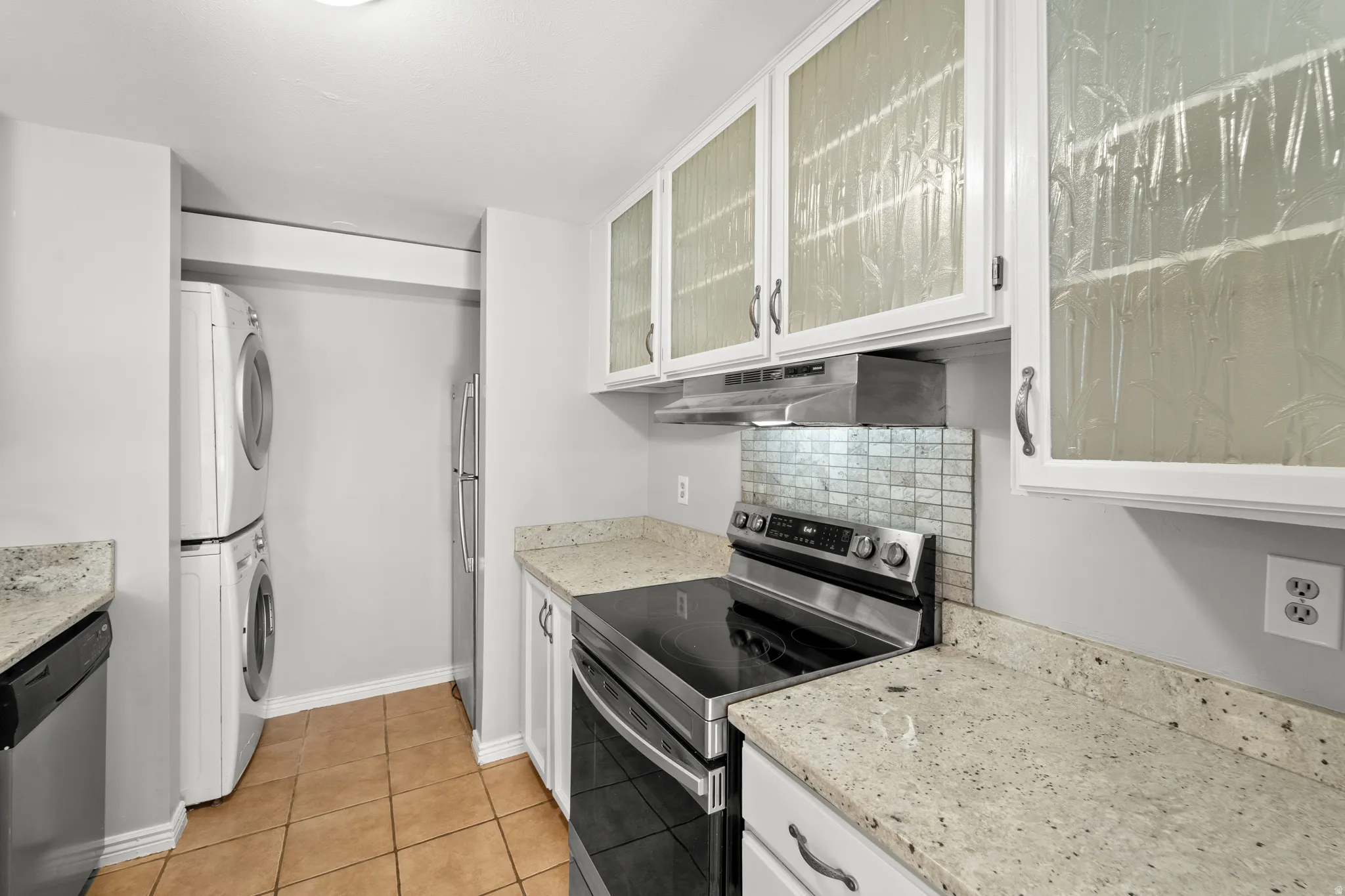 Stainless steel appliances complement the kitchen's contemporary design.