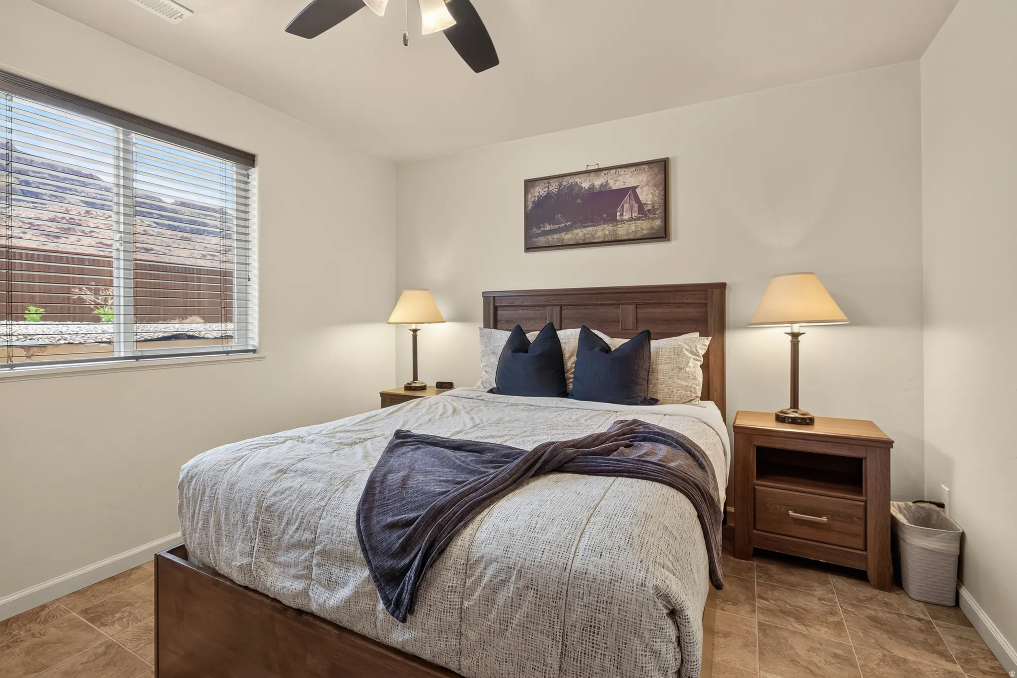 Interior room featuring warm-toned walls, tiled flooring, and a ceiling fan