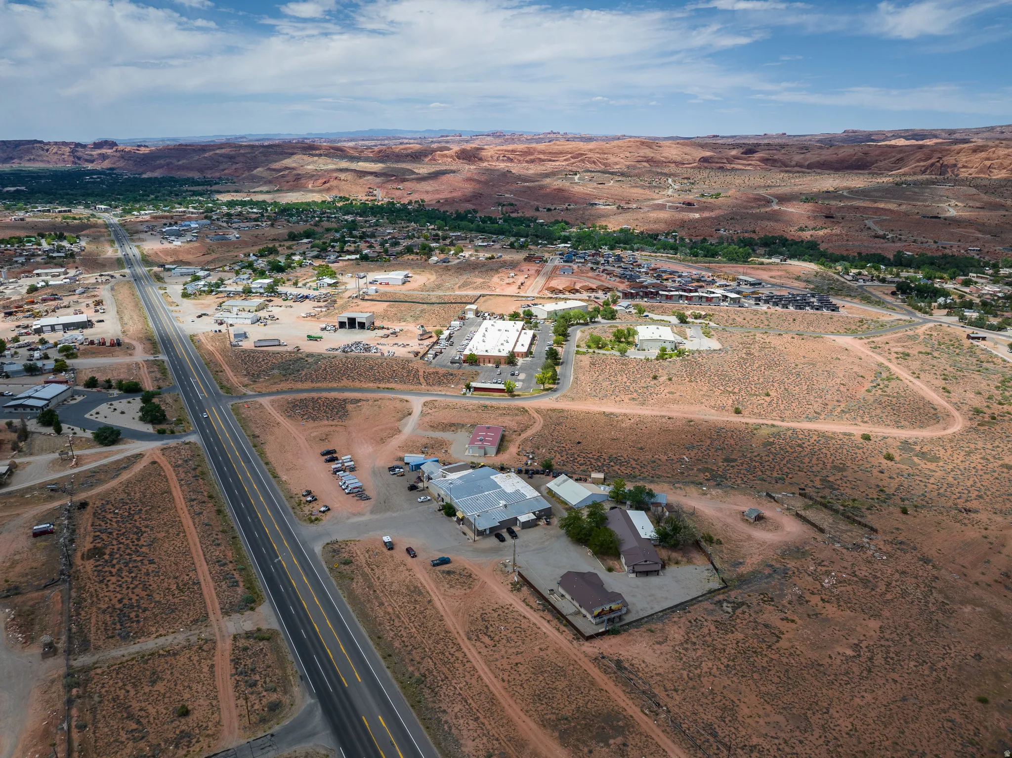 Aerial perspective of a developed area with a prominent paved road