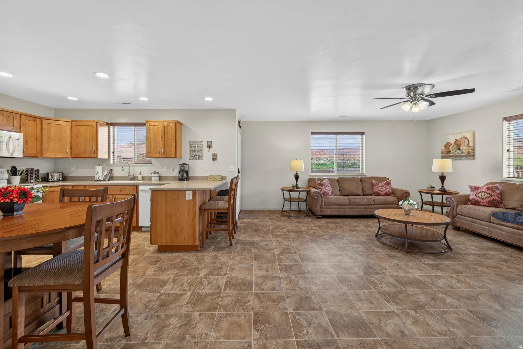 Spacious kitchen and living area featuring tile flooring