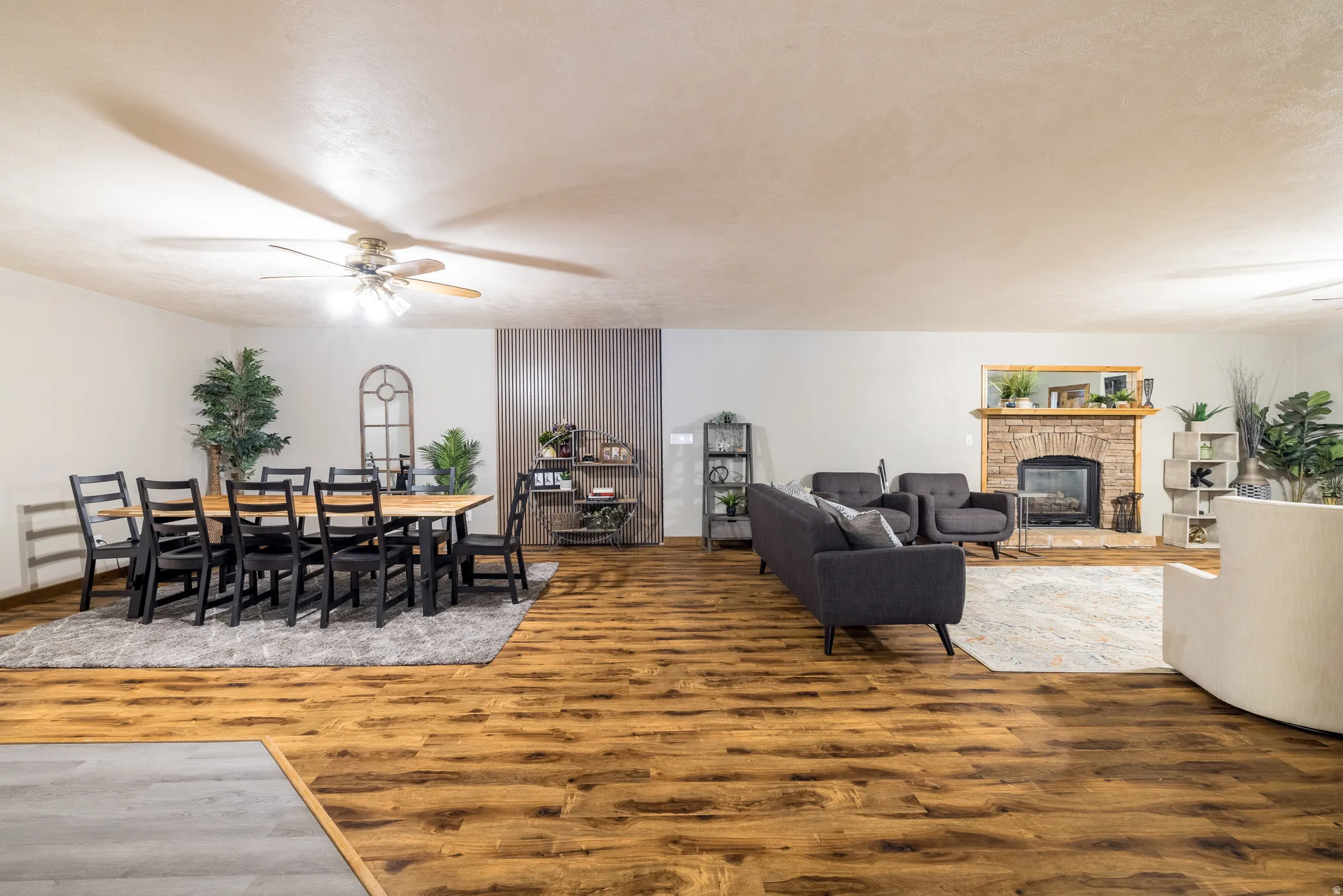 Spacious room featuring wood-finish flooring throughout