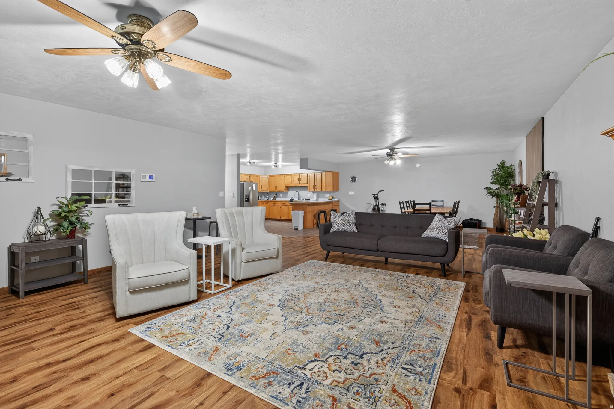 Open-concept living space featuring wood-finish flooring and light gray walls