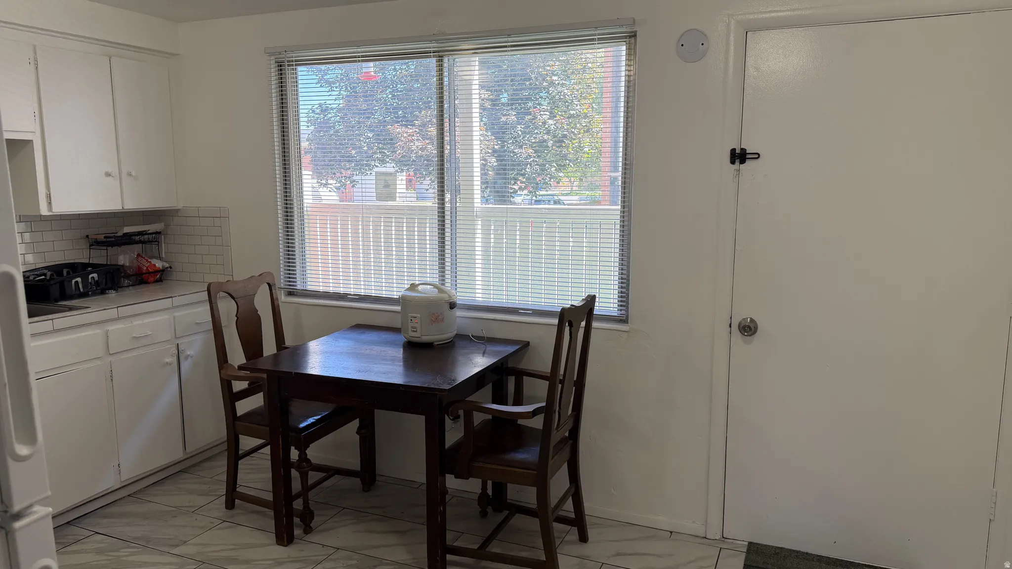 Kitchen featuring a dining area and the door to the private patio overlooking the courtyard