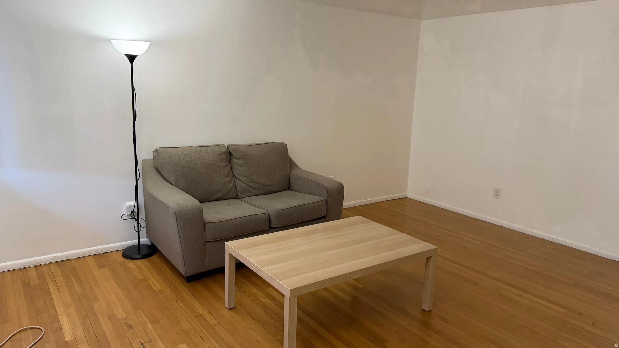 Spacious living room with hardwood flooring
