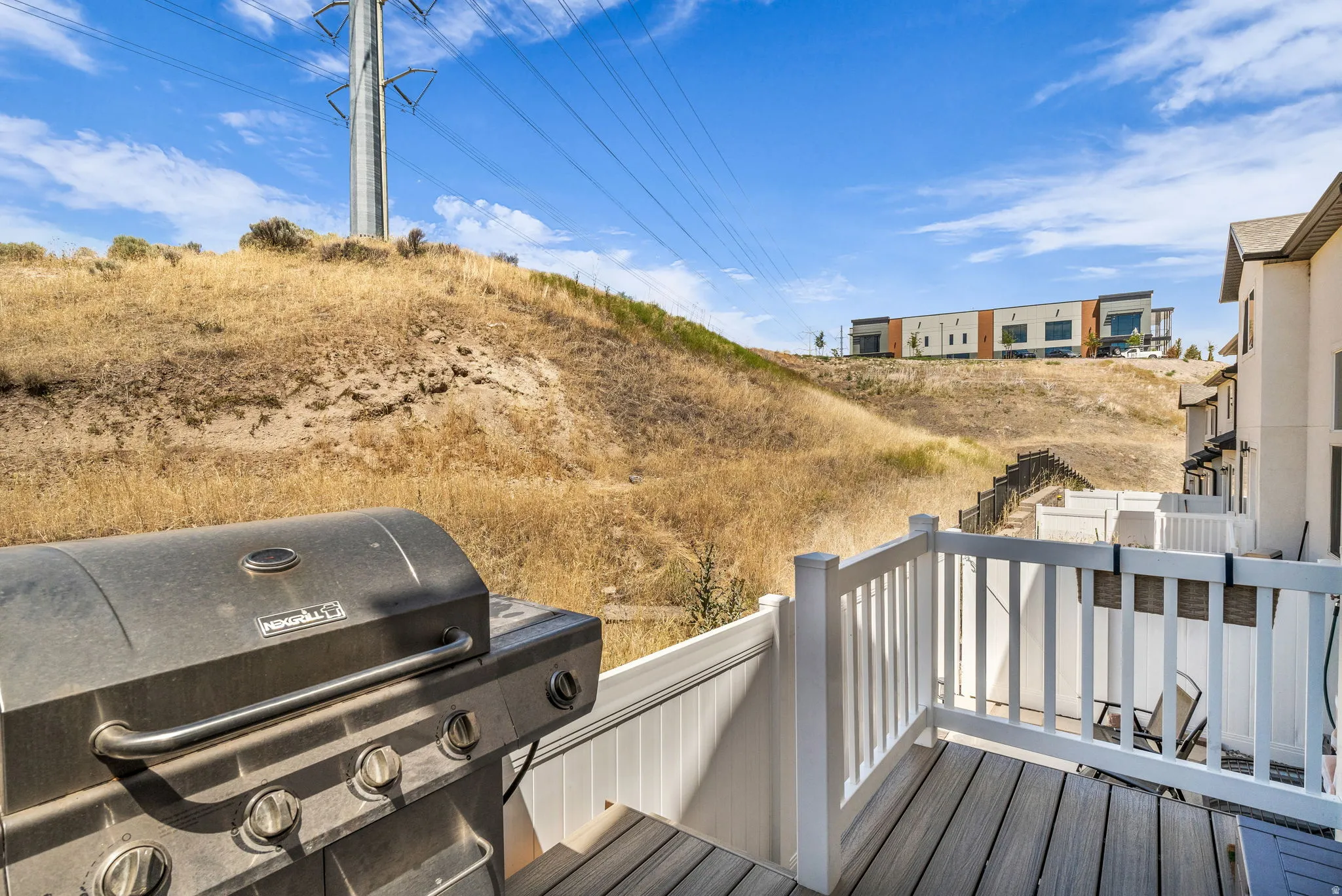 Outdoor deck featuring wood-finish flooring and white railing