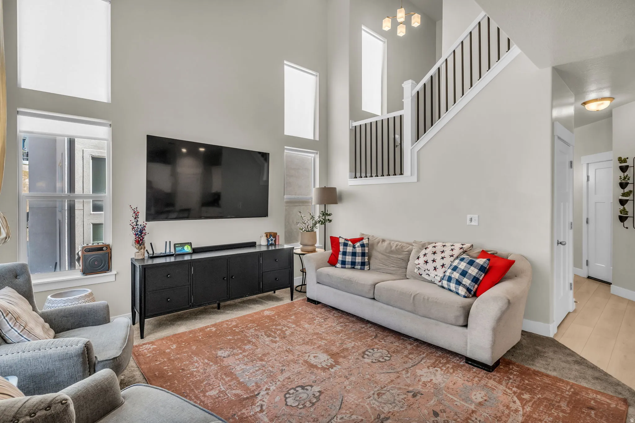 Living area with high ceilings and multiple windows