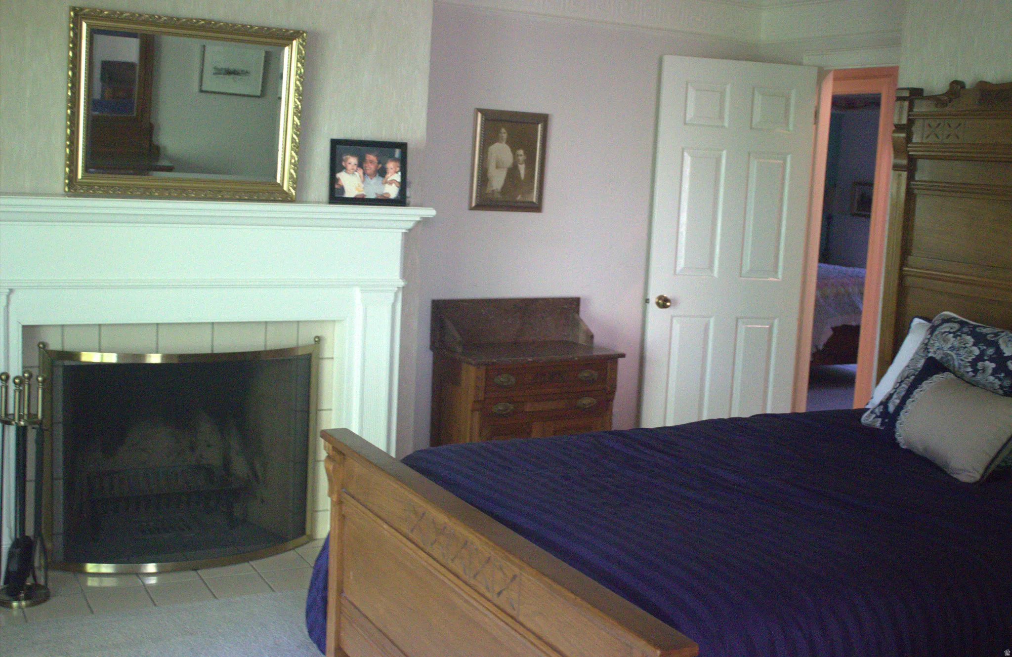 Fireplace with white mantel and tile surround