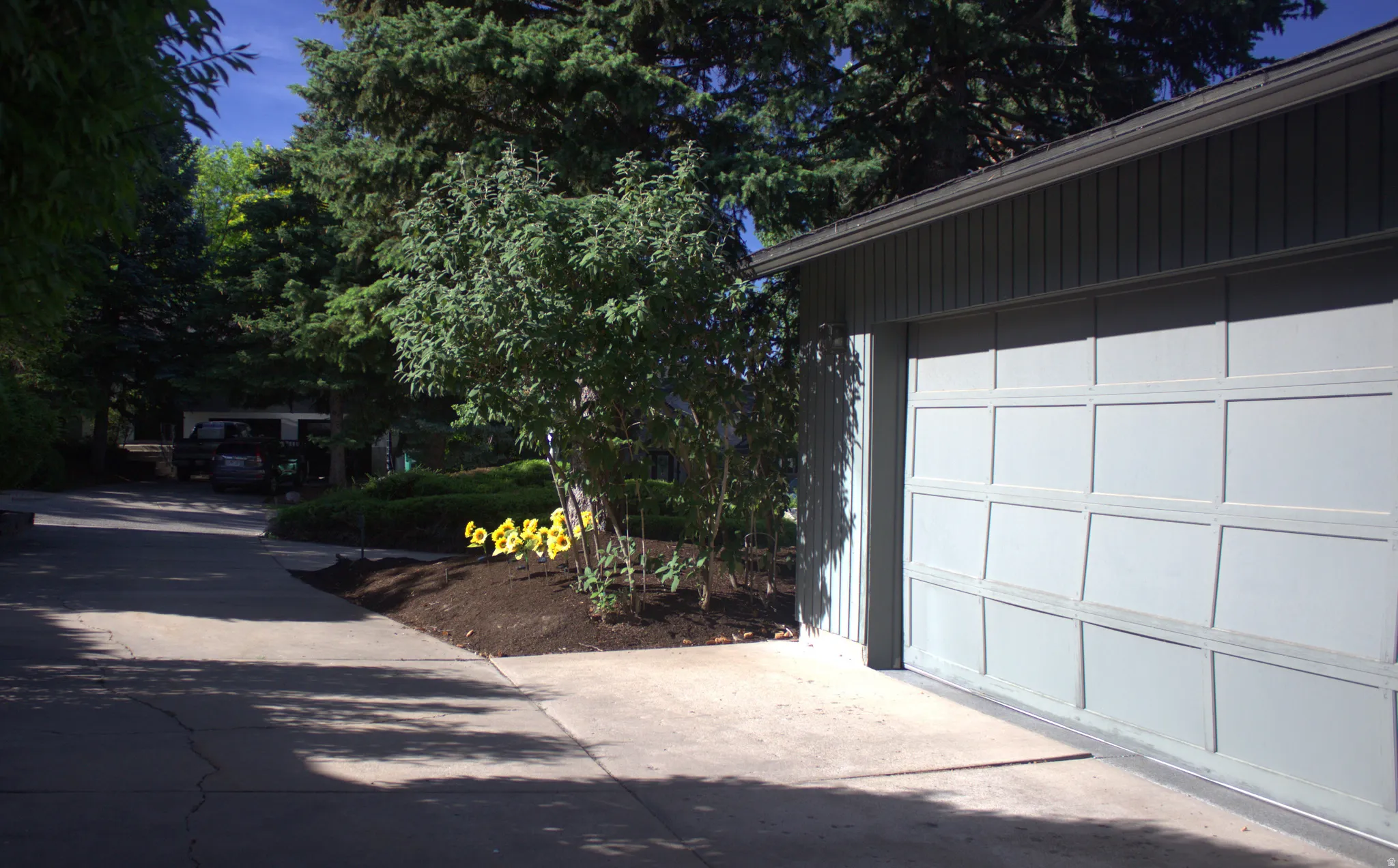 Panel-style garage door with vertical siding and gutters