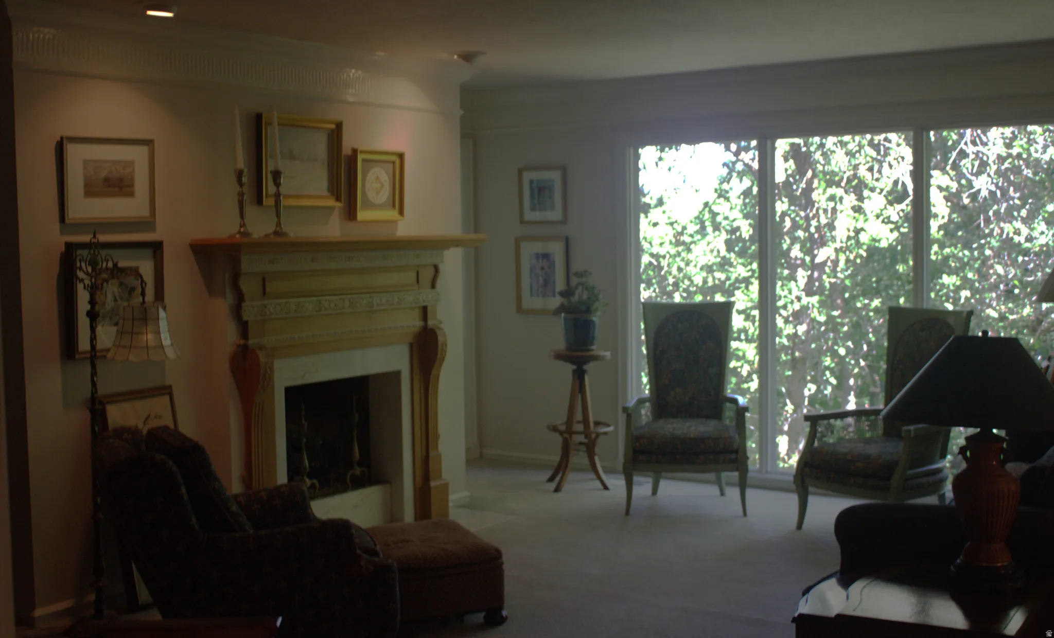 Fireplace with an ornate wood mantel and stone surround