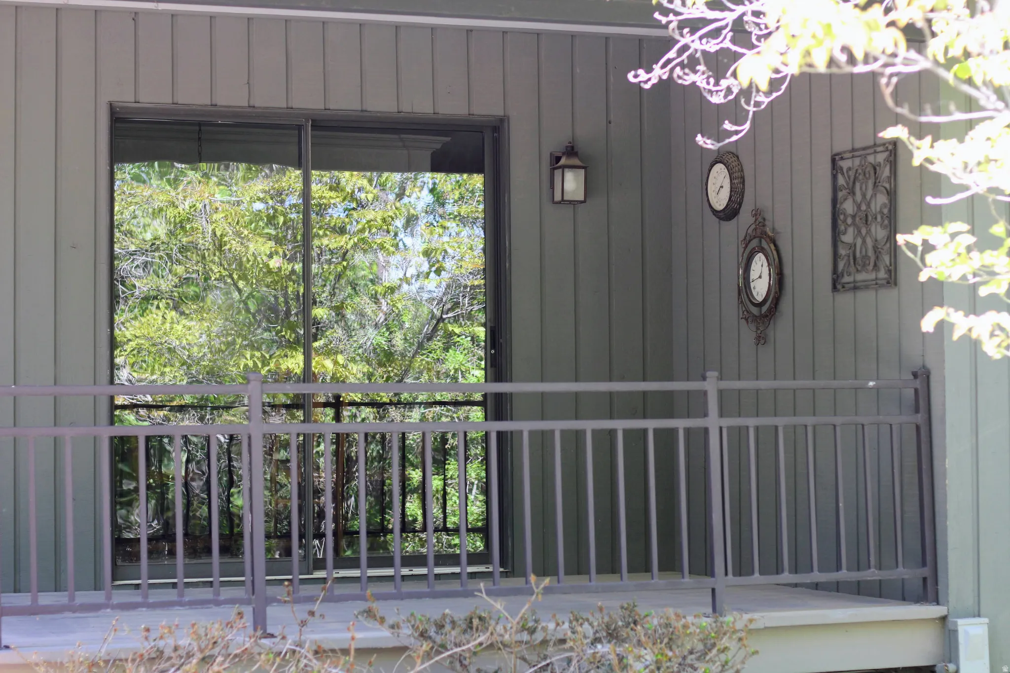Exterior balcony featuring metal railings and a sliding glass door