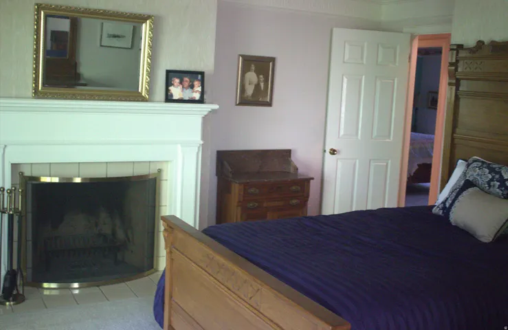 Fireplace with white mantel and tile surround