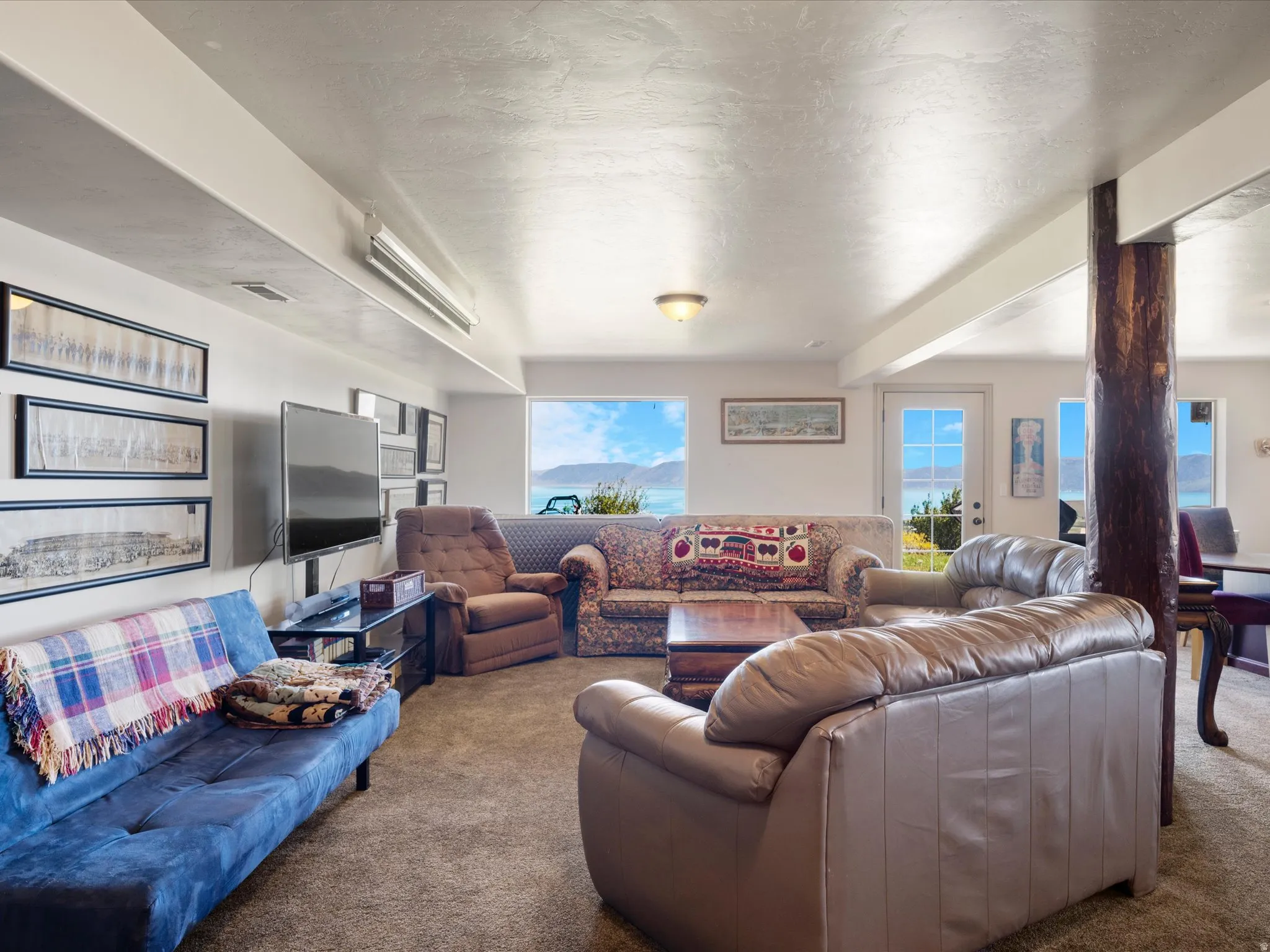 Family room with exterior walk out door and water view