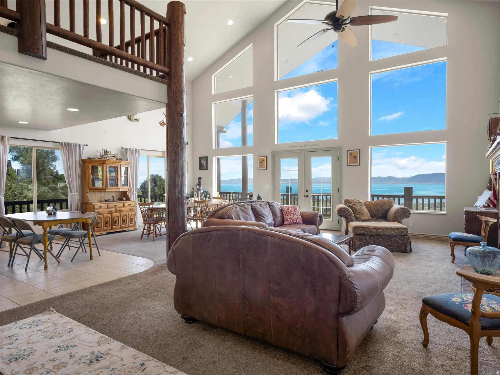 Vaulted ceilings with expansive windows offering waterfront scenery