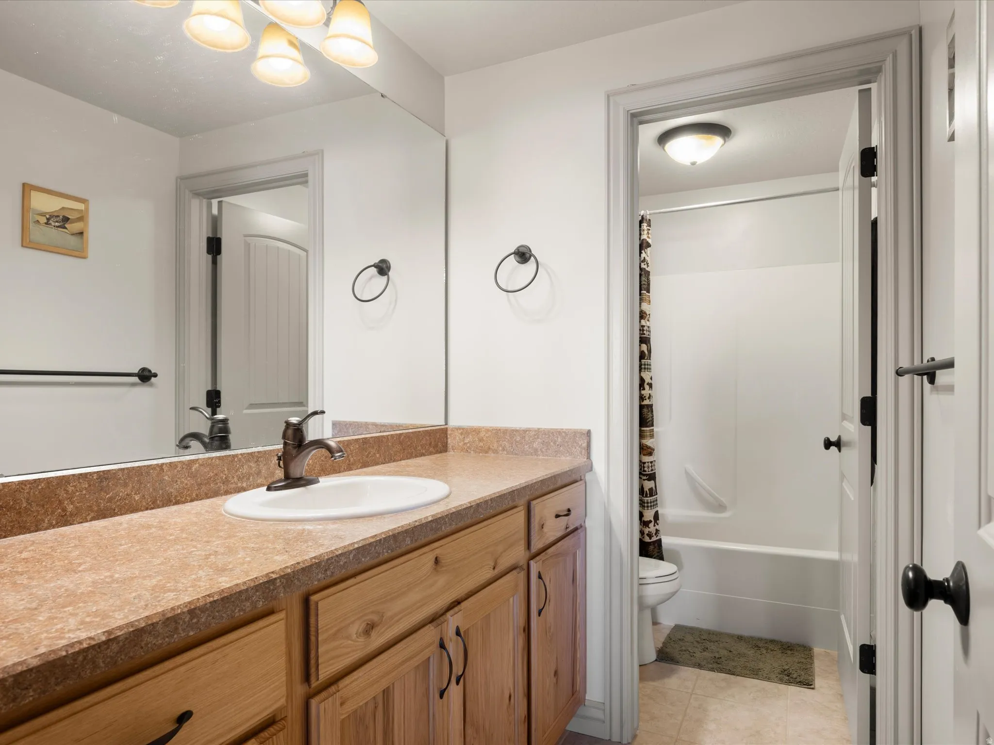Bathroom vanity featuring wood-finish cabinetry and a single basin sink