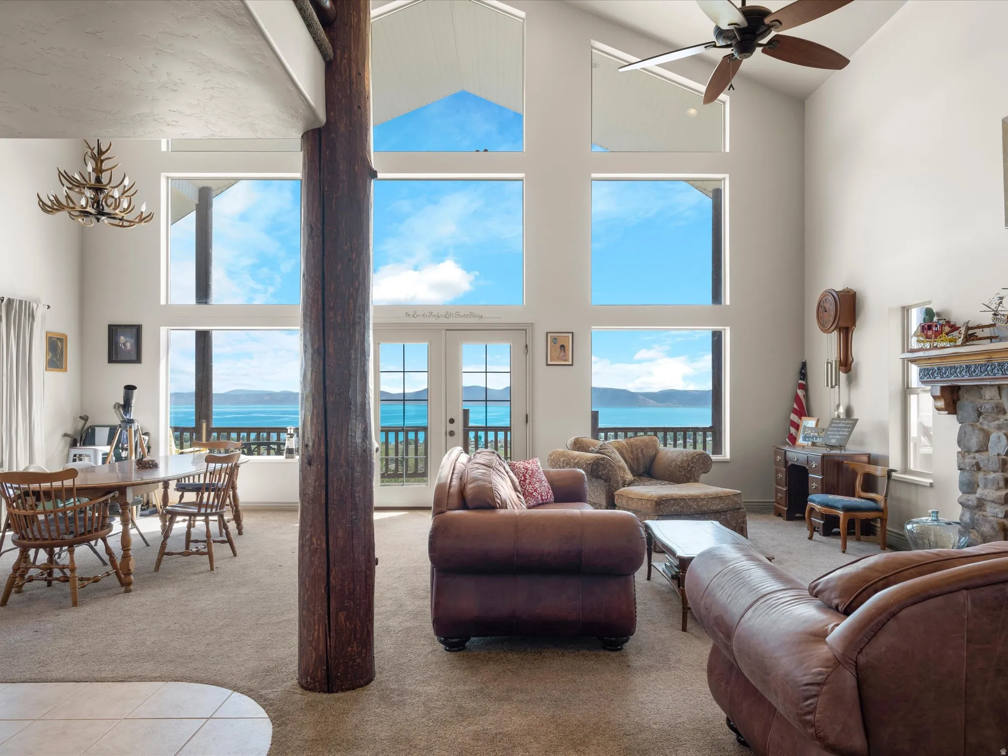 Living room featuring window wall and water view