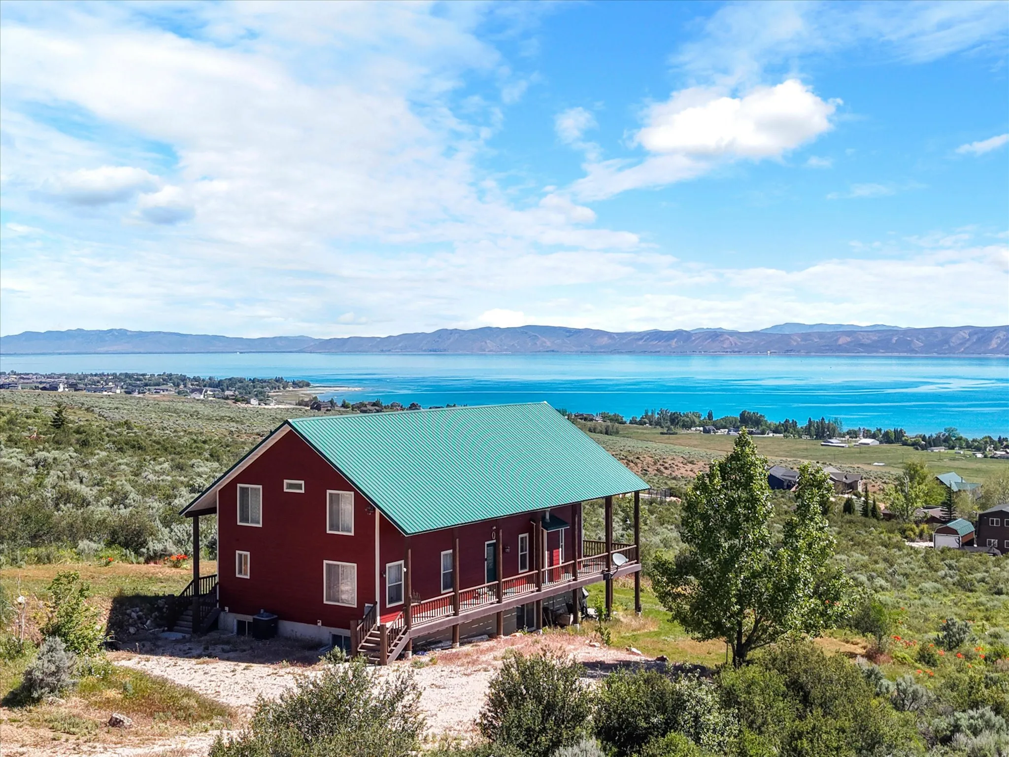 Red exterior with a green metal roof with water view