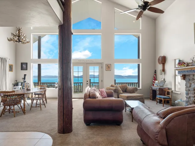 Living room featuring window wall and water view