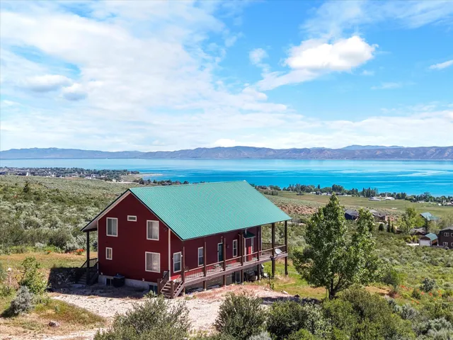 Red exterior with a green metal roof with water view
