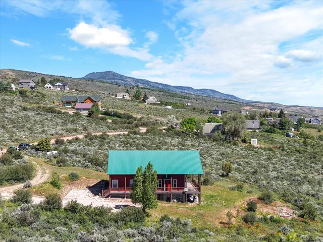Red exterior home with a vibrant green metal roof